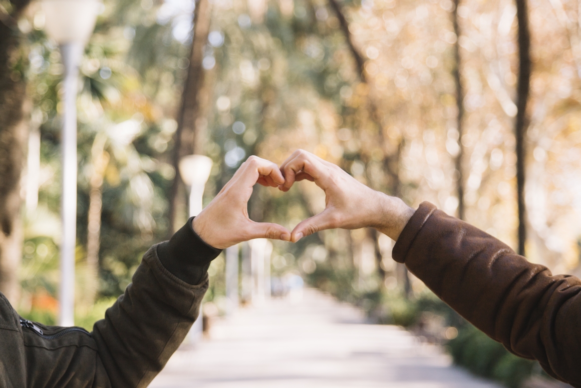 crop-men-stacking-hands-showing-heart crop-men-stacking-hands-showing-heart