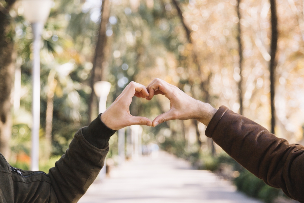 crop-men-stacking-hands-showing-heart