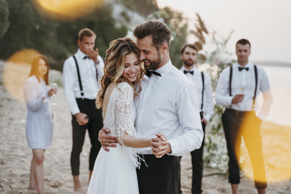 beautiful-bride-groom-having-their-wedding-with-guests-beach