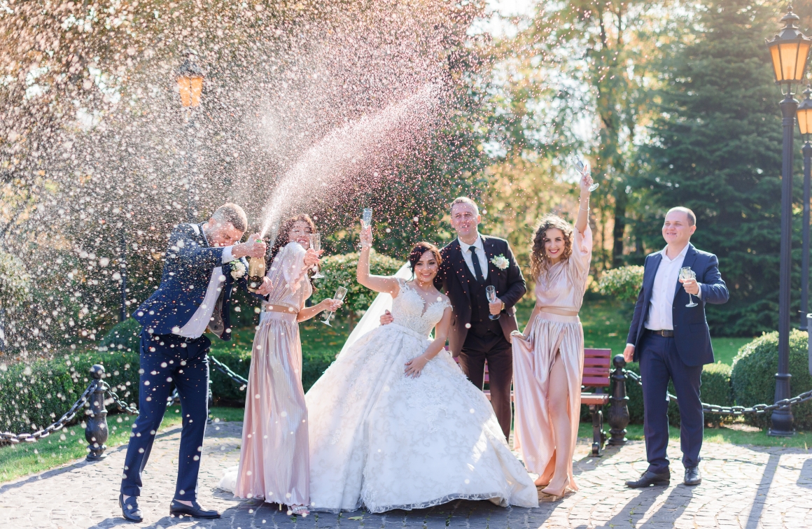 wedding-couple-best-friends-are-drinking-champagne-celebrating-park-wedding-day_0