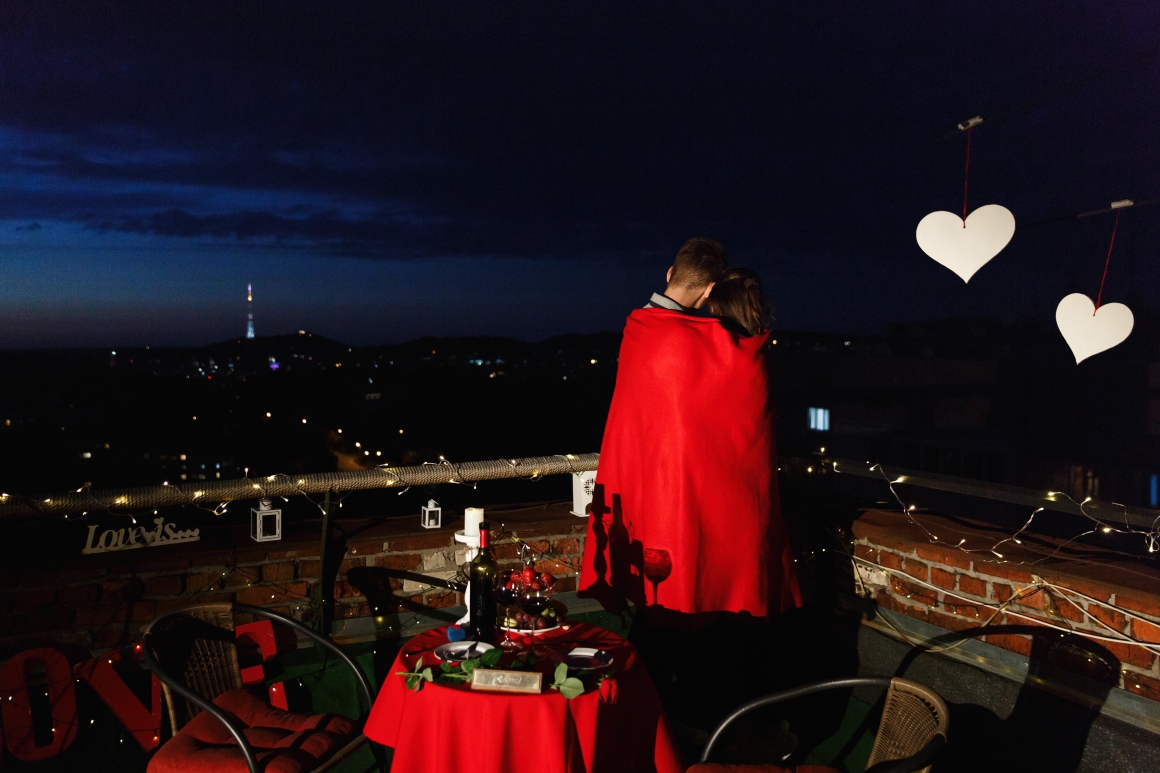 boy-girl-hug-each-other-tender-standing-rooftop-rays-evening-lights