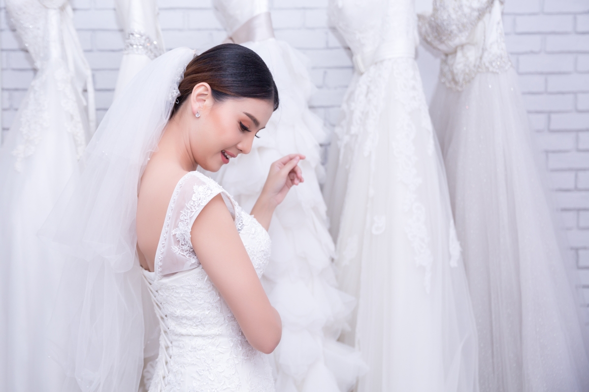 asian-young-woman-bride-trying-wedding-dress-modern-wedding